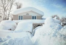 Blizzard Rage: Neighbor BURIES Family’s SUV A house surrounded by deep snow drifts after a heavy snowfall