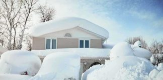 A house surrounded by deep snow drifts after a heavy snowfall