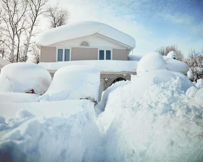 A house surrounded by deep snow drifts after a heavy snowfall