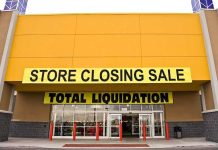 Exterior of a store with a large sign announcing a closing sale and total liquidation