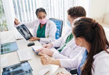 Emergency Scan Reveals CATASTROPHIC Medical Failure Doctors discussing chest X-ray results at a workstation.