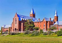 Jews HUNTED on American Campus—FBI Silent Large red brick building with turrets and green lawn.