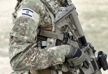 IDF DECAPITATES Commander Overnight Soldier in camouflage gear with Israeli flag patch.