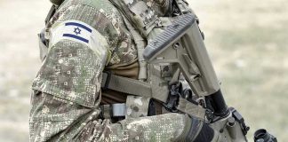 IDF DECAPITATES Commander Overnight Soldier in camouflage gear with Israeli flag patch.