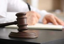 Supreme Court Guts Conversion Therapy Ban Judges gavel on desk with person writing.