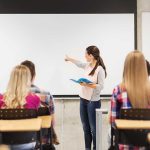 A teacher presenting to students in a classroom