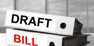 Two file folders labeled DRAFT and BILL stacked on a desk