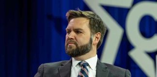 VANCE TASK FORCE BUSTS Massive Hospice Scam Man in a suit with a thoughtful expression.