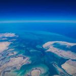 Aerial view of coastline and ocean.