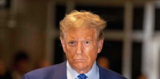 Trump UNLOADS On Springsteen—Fans Split Man in blue suit and striped tie, serious expression.