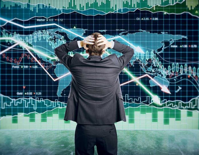 351140789 Person in front of falling stock market graph.