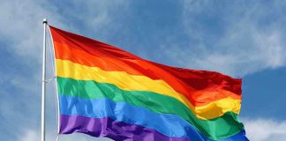 Idaho BANS Pride Flags — City’s Revenge STUNS A rainbow flag waving against a blue sky