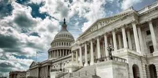 The U.S. Capitol building with a cloudy sky backdrop