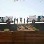 Trumps Top Chief QUITS Amid Scandal Border Patrol vehicles and agents on a ridge.