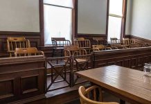 Judge CAUGHT Having Sex With Cop Inside Courthouse! Empty jury box and table in courtroom.