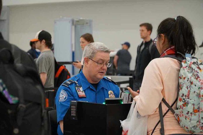 1641623299 TSA agent checks passengers documents at airport security.