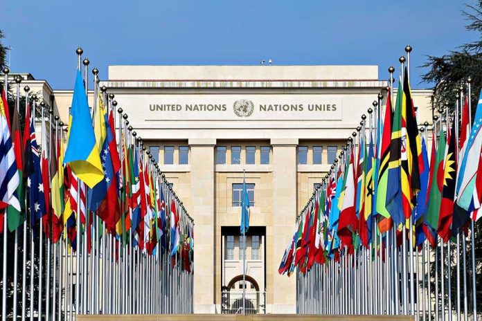 423802144-3 United Nations building with numerous national flags outside.