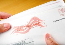 Judge’s Decision SHOCKS Trump’s Mail-In Voting Order A hand holding an envelope labeled Official Election Mail