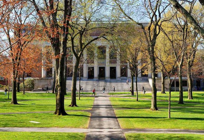 shutterstock_131270519 Students walking on a university campus with autumn trees and a historic building in the background