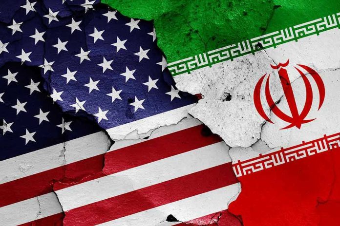 1152300314-2 Cracked American and Iranian flags on a wall.