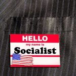 Hello my name is Socialist name tag on suit.