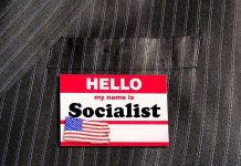 Rep DEMANDS Rule Banning Socialists From Serving in Congress Hello my name is Socialist name tag on suit.