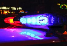 Masked Gunmen SNATCH Journalist From Home Police car lights flashing red and blue.