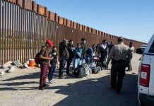 Border Czar Shares HORRIFIC ICE Prison Scene Border patrol agents interact with a group of people.