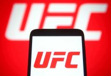 Patriotic Fighter Delivers EPIC Line During UFC Event! UFC logo on phone screen and background.