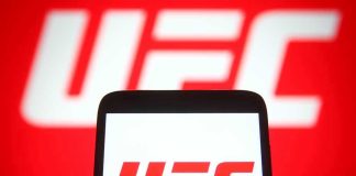 Patriotic Fighter Delivers EPIC Line During UFC Event! UFC logo on phone screen and background.