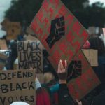 BLM Leader Issues Most RACIST Chant Yet! Crowd holding Black Lives Matter signs at a protest.