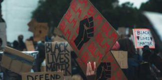 BLM Leader Issues Most RACIST Chant Yet! Crowd holding Black Lives Matter signs at a protest.