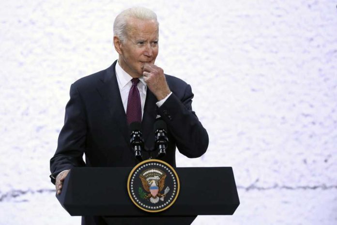 A man in a suit speaking at a podium with a presidential seal