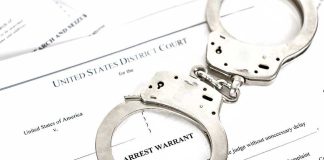 Plane Hijacker Awaiting Deportation RELEASED by Activist Judge Handcuffs on top of an arrest warrant document.