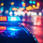 Court PROTECTS Killer Cop After Lie! Police car with flashing lights at night.