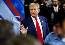 Midnight War: Trump Goes on Expletive Rant! A man in a suit with a red tie speaking at a political event