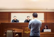 Convict SWAPS Gender Last-Minute Sparking Legal Uproar defendant stands before judges in a courtroom