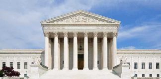 SCOTUS Decision Hands China The Advantage Front view of the Supreme Court building with large columns and steps under a blue sky