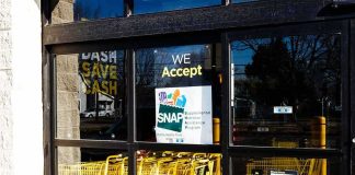 America’s Largest Welfare State Revealed Store entrance with yellow shopping carts behind glass doors