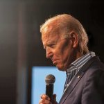 Court Issues DAMNING Biden Verdict – Karma! elderly man holding a microphone on stage