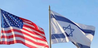 American and Israeli flags waving against a clear sky.