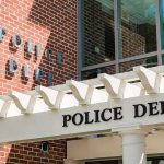Police department entrance with pergola and brick wall