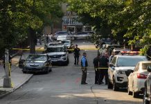 Famed NFL Broadcaster ARRESTED – Caught in Sting Op! Police officers secure a residential street with patrol cars and yellow tape