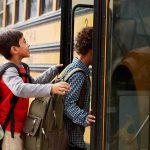 Children boarding a yellow school bus