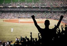 MLB Fan SLAPS Young Supporter During Anthem Crowd of fans cheering at a baseball game in a stadium