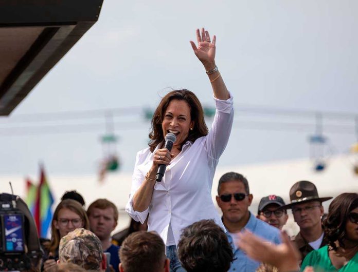 147618444 Woman speaking at outdoor event with raised hand.