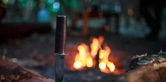Bucket-List Hike Turns BLOODY Ambush Hunting knife stuck in a log near a campfire