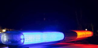 Police car light bar flashing blue and red at night