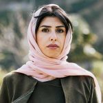 Woman in a pink headscarf outdoors