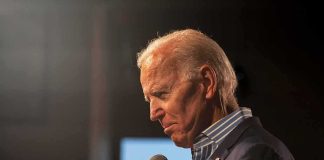 elderly man holding a microphone on stage